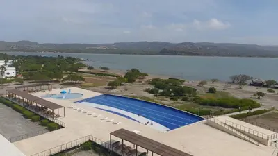 an aerial view of a swimming pool next to a lake at Marina Puerto Velero Cabaña in Tubará