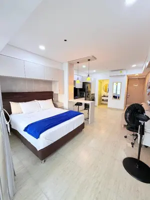 a bedroom with a large bed and a desk at Cartagena Beach exclusive & Resort in Cartagena de Indias