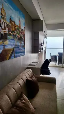 a living room with a couch and a painting on the wall at Cartagena Beach exclusive & Resort in Cartagena de Indias