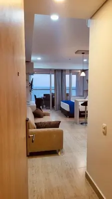 a living room with a couch and a living room with a table at Cartagena Beach exclusive & Resort in Cartagena de Indias