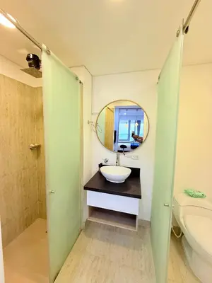 a bathroom with a sink and a mirror and a toilet at Cartagena Beach exclusive & Resort in Cartagena de Indias