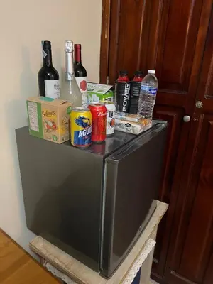 a refrigerator with drinks and food on top of it at hermosa habitacion in Barranquilla