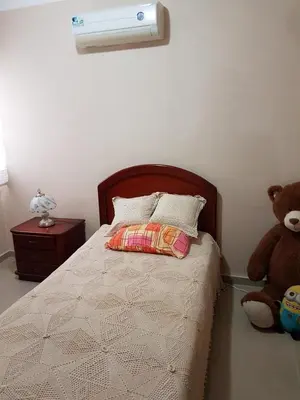 a bedroom with a bed with a stuffed teddy bear at hermosa habitacion in Barranquilla