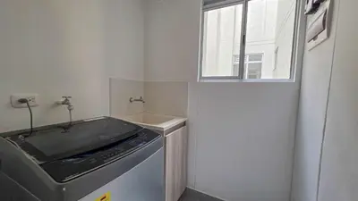 a laundry room with a sink and a window at Capriella, Serena Del Mar in Cartagena de Indias