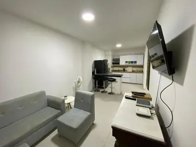 a living room with a couch and a television at Experience the magic of the Calle de las Damas historic center in Cartagena de Indias