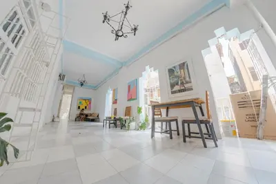 a room with a table and paintings on the wall at Experience the magic of the Calle de las Damas historic center in Cartagena de Indias