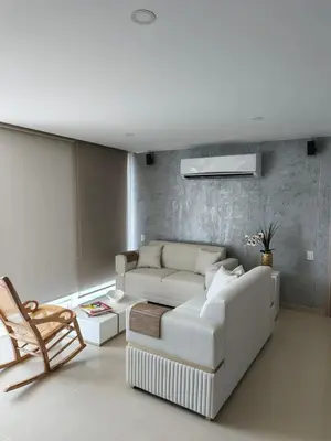 a living room with a white couch and a chair at 612 Beautiful Apartment Near the Walled City in Cartagena de Indias