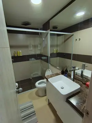 a bathroom with a white sink and a toilet at 612 Beautiful Apartment Near the Walled City in Cartagena de Indias