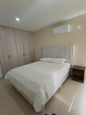a bedroom with a white bed with a white bedspread at 612 Beautiful Apartment Near the Walled City in Cartagena de Indias