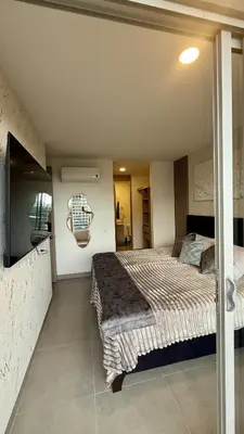 a bedroom with a large bed in a room at Aqua Marine Suite - Santa Marina Condo in Santa Marta