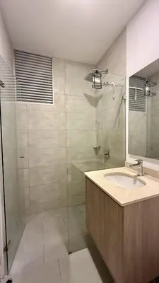 a bathroom with a sink and a glass shower at Aqua Marine Suite - Santa Marina Condo in Santa Marta