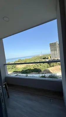 a large window in a room with a view of the ocean at Aqua Marine Suite - Santa Marina Condo in Santa Marta