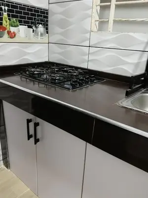 a kitchen counter with a stove top in a kitchen at Apartamento cerca a la playa y al aeropuerto in Santa Marta