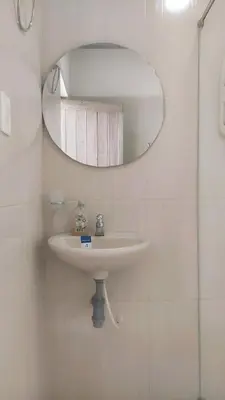 a bathroom with a white sink and a mirror at Apartamento cerca a la playa y al aeropuerto in Santa Marta