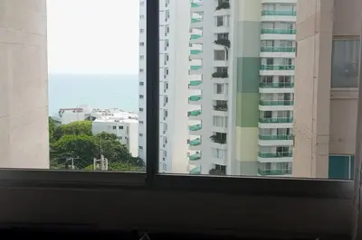 a window with a view of the ocean and buildings at Beatifull apartment near Hilton hotel in Cartagena de Indias