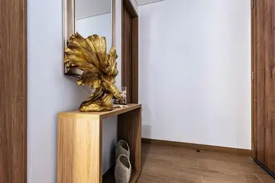 a gold sculpture on a wooden stand in front of a mirror at NEW Apartment, best rooftop pool view, Cartagena - Visitors NOT ALLOWED in Cartagena de Indias