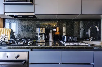 a kitchen with a stove and a counter top at NEW Apartment, best rooftop pool view, Cartagena - Visitors NOT ALLOWED in Cartagena de Indias