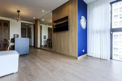 a living room with a blue wall and a clock at NEW Apartment, best rooftop pool view, Cartagena - Visitors NOT ALLOWED in Cartagena de Indias