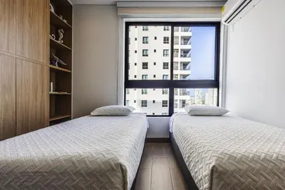 two beds in a room with a window at NEW Apartment, best rooftop pool view, Cartagena - Visitors NOT ALLOWED in Cartagena de Indias