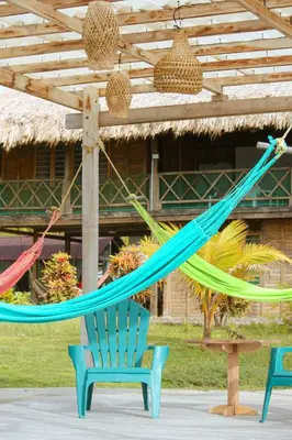 a hammock hanging from a wooden pergola at Sarao Mar in Moñitos