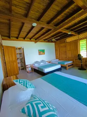 a bedroom with two beds and a swimming pool at Sarao Mar in Moñitos