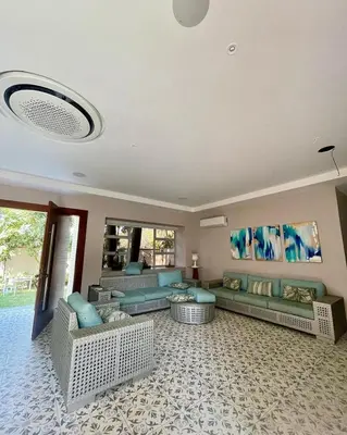 a large living room with couches and tables at Hermosa Villa de Lujo, De Kabaña in Santa Veronica