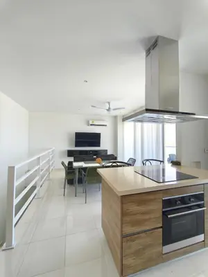 a kitchen with a counter and a table with chairs at Apto puerto velero in Barranquilla