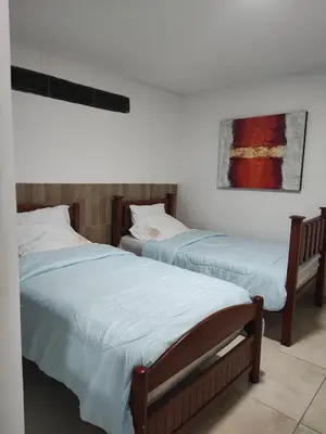 two beds sitting next to each other in a bedroom at Hotel WK Casa de Hospedaje in Barranquilla