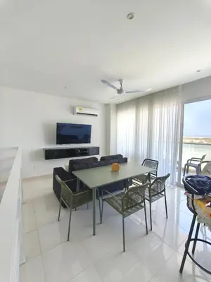 a living room with a table and chairs and a couch at Apto 411 puerto velero in Tubará