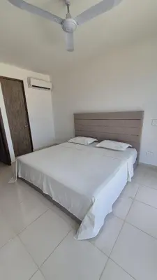a white bedroom with a bed with a ceiling at Apto 411 puerto velero in Tubará