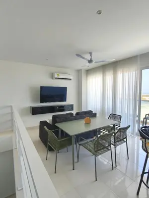 a living room with a table and a couch at Apto 411 puerto velero in Tubará