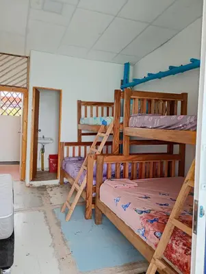 a bedroom with three bunk beds in a room at Paraíso de corales in Playa Blanca