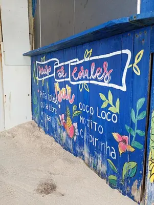 a blue wall with graffiti on it at Paraíso de corales in Playa Blanca