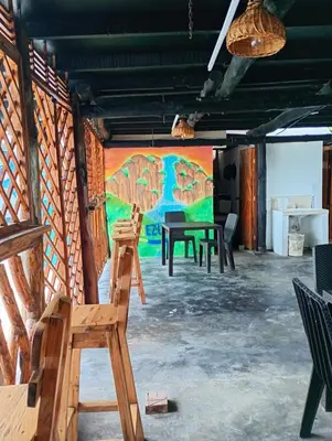 a room with tables and chairs in front of a mural at Paraíso de corales in Playa Blanca