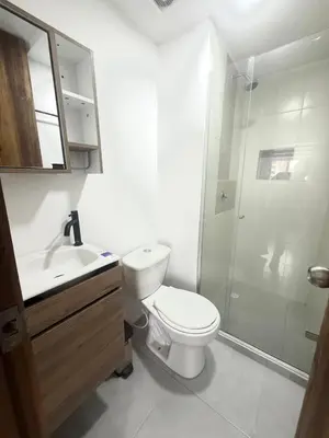 a white bathroom with a toilet and a shower at Hermoso Apartamento con vista al mar in Cartagena de Indias