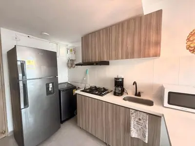a kitchen with a stainless steel refrigerator and a sink at Hermoso Apartamento con vista al mar in Cartagena de Indias