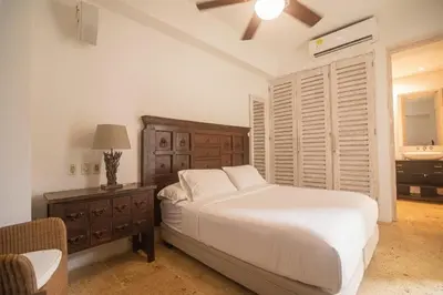 a bedroom with a bed and a table and a window at Casa Del Hobo in Cartagena de Indias