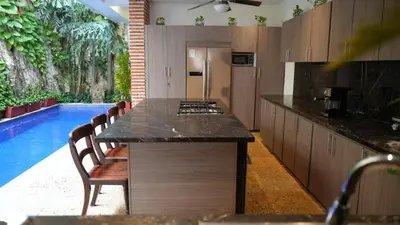 a kitchen with a counter top and a swimming pool at Casa Del Hobo in Cartagena de Indias
