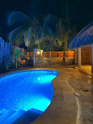 a swimming pool in a resort at night at Cabaña de Lujo en Isla Fuerte VIP in Isla Fuerte