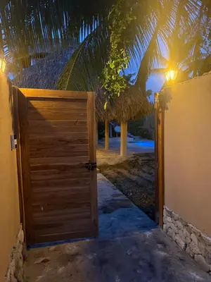 a wooden door leading to a beach at night at Cabaña de Lujo en Isla Fuerte VIP in Isla Fuerte