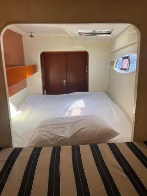 a small bedroom with a bed in the middle of it at Catamaran in Cartagena Bay in Cartagena de Indias