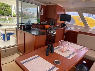 a kitchen with a wooden table in a boat at Catamaran in Cartagena Bay in Cartagena de Indias