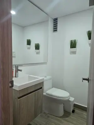 a bathroom with a toilet and a sink and a mirror at Brand New, Perfectly Located 2-2 in CieloMar! in Cartagena de Indias