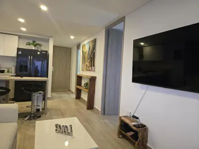 a living room with a couch and a tv on a wall at Brand New, Perfectly Located 2-2 in CieloMar! in Cartagena de Indias