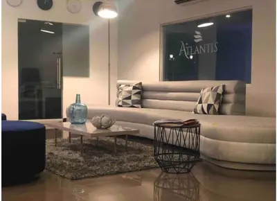 a living room with a large couch and a table at Apartasuites Amoblados Norte de Barranquilla-Atlantis Suites in Barranquilla