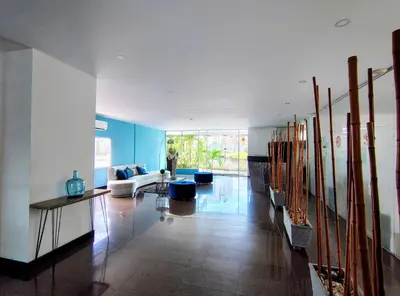 a living room with a couch and a table at Apartasuites Amoblados Norte de Barranquilla-Atlantis Suites in Barranquilla