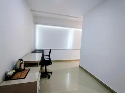 an office with a desk and a chair in a room at Apartasuites Amoblados Norte de Barranquilla-Atlantis Suites in Barranquilla