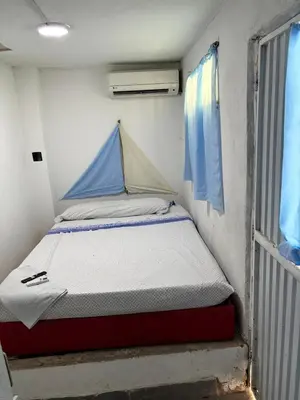 a small bed in a small room next to a window at Hostel cartagena in Cartagena de Indias