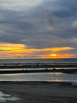 a sunset on a beach with the ocean at Hostel cartagena in Cartagena de Indias