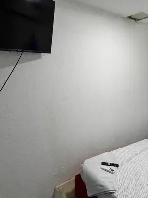 a tv hanging on a wall in a room at Hostel cartagena in Cartagena de Indias